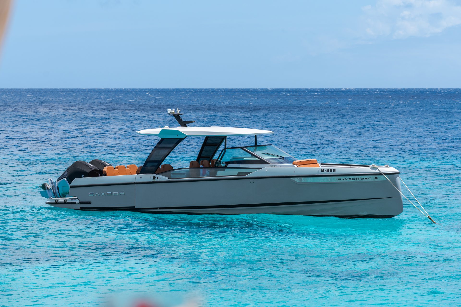 Day boat on clear blue water off the villa